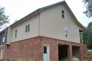 A steel floor joist kit allows this home to be built over a walk-in basement garage