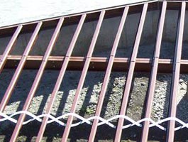 Steel floor joists connect to a rim joist